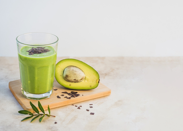 A Smoothie made with avocados and chocolate nibs.