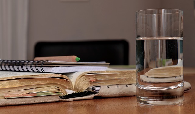 Glass of Water With Books For Studying.
