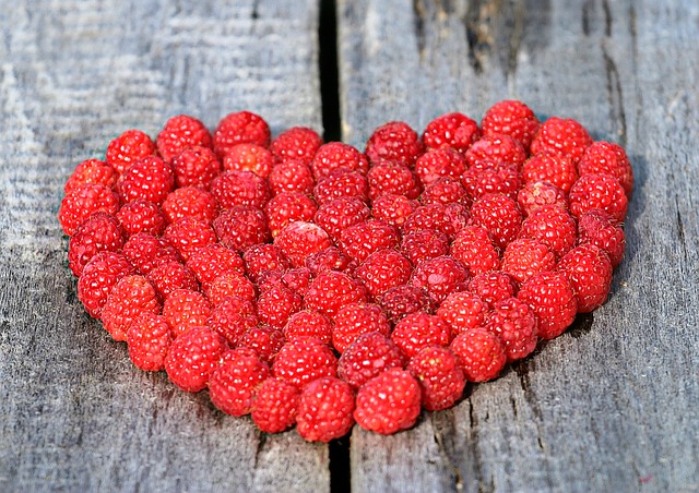 Raspberries formed in the shape of a heart.
