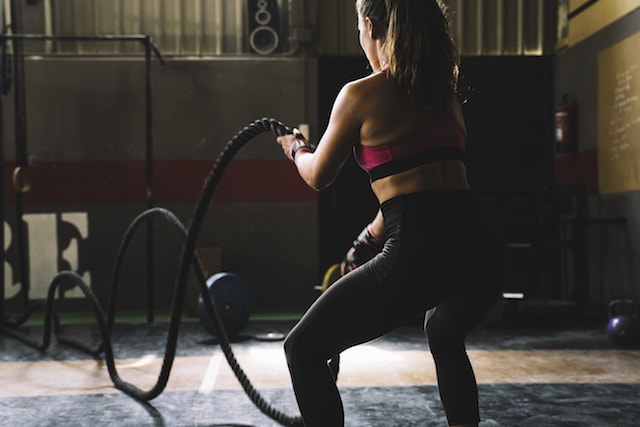 woman doing intense rope exercises. 